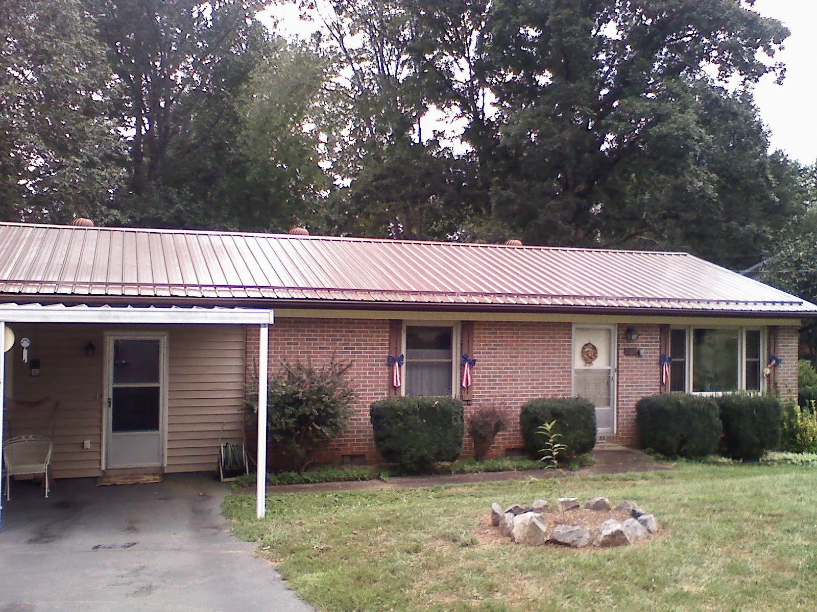 Bronze metal roof and carport on a brick ranch home — Roof Repair work by our crew in La Fayette